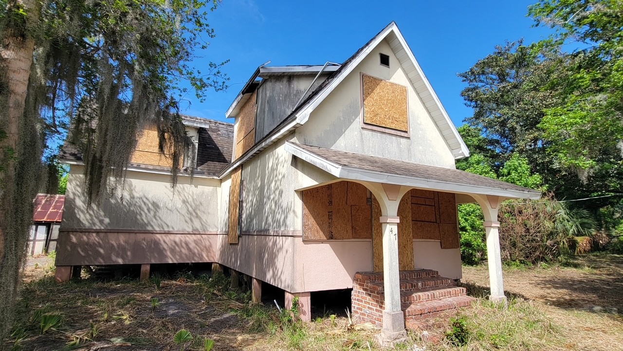 Finished boarded-up windows and doors securing an idle property