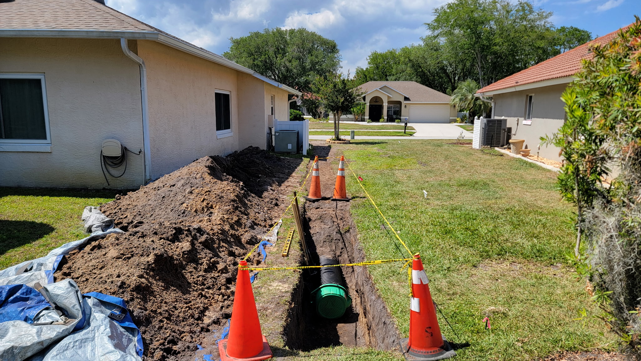 Catch basin and drain pipe installed at a low point in a front yard