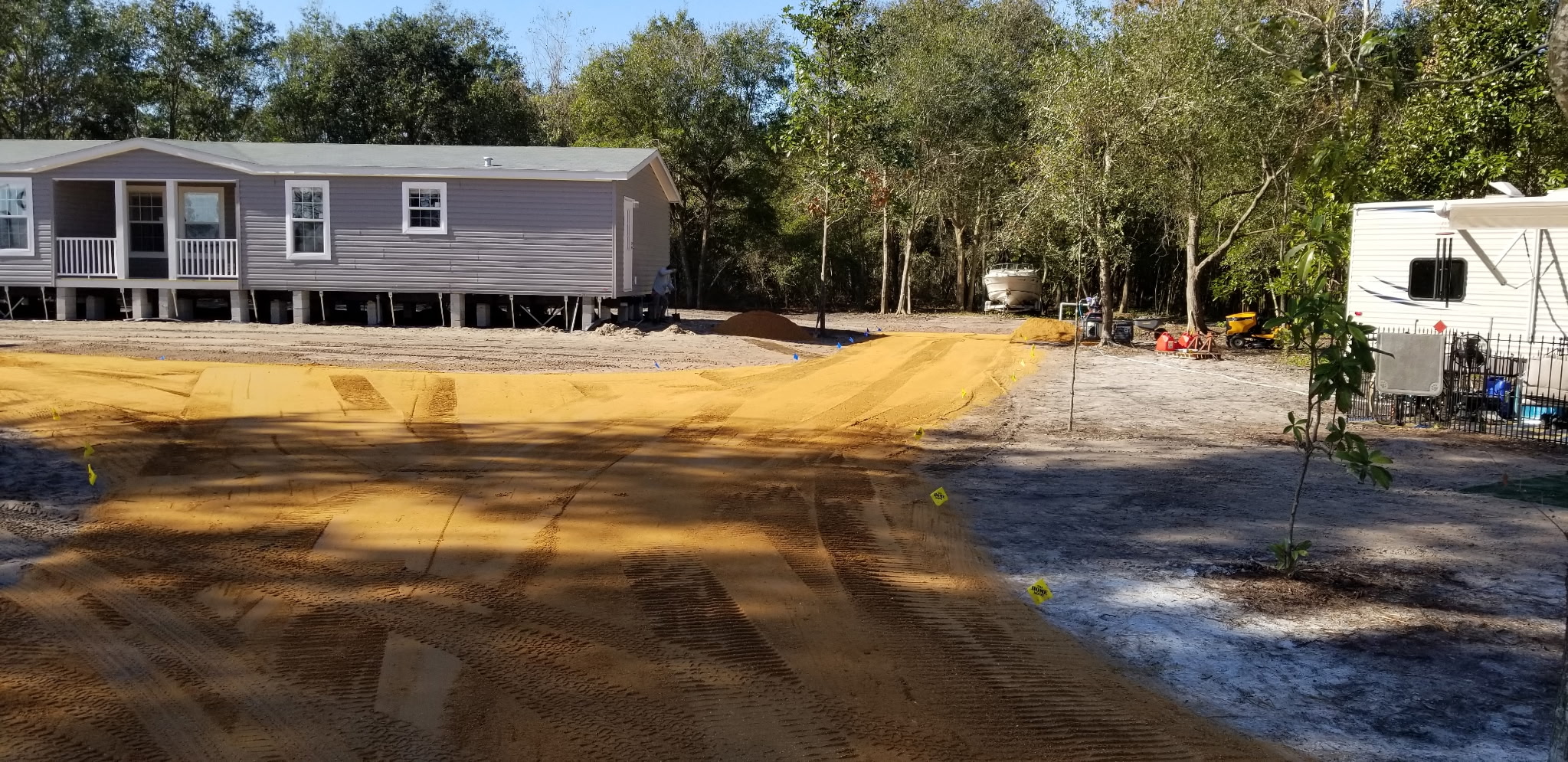 New sand driveway graded for a rural mobile home property