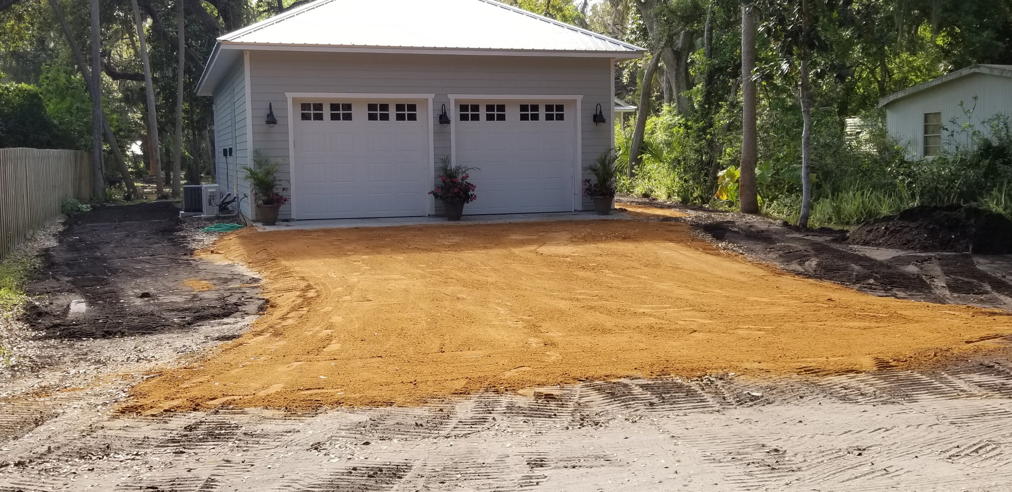 Freshly graded shell driveway leading to a Palm Coast home
