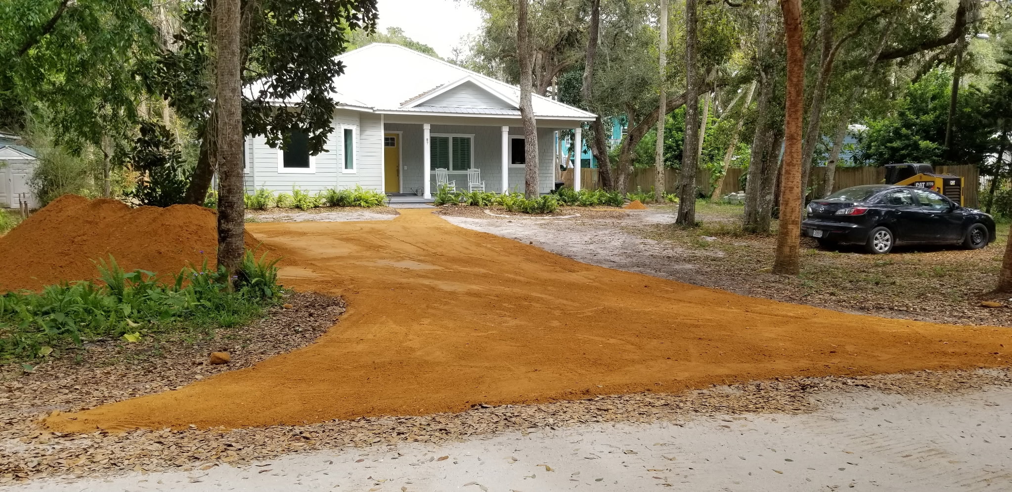 Freshly graded clay driveway in front of a Palm Coast home