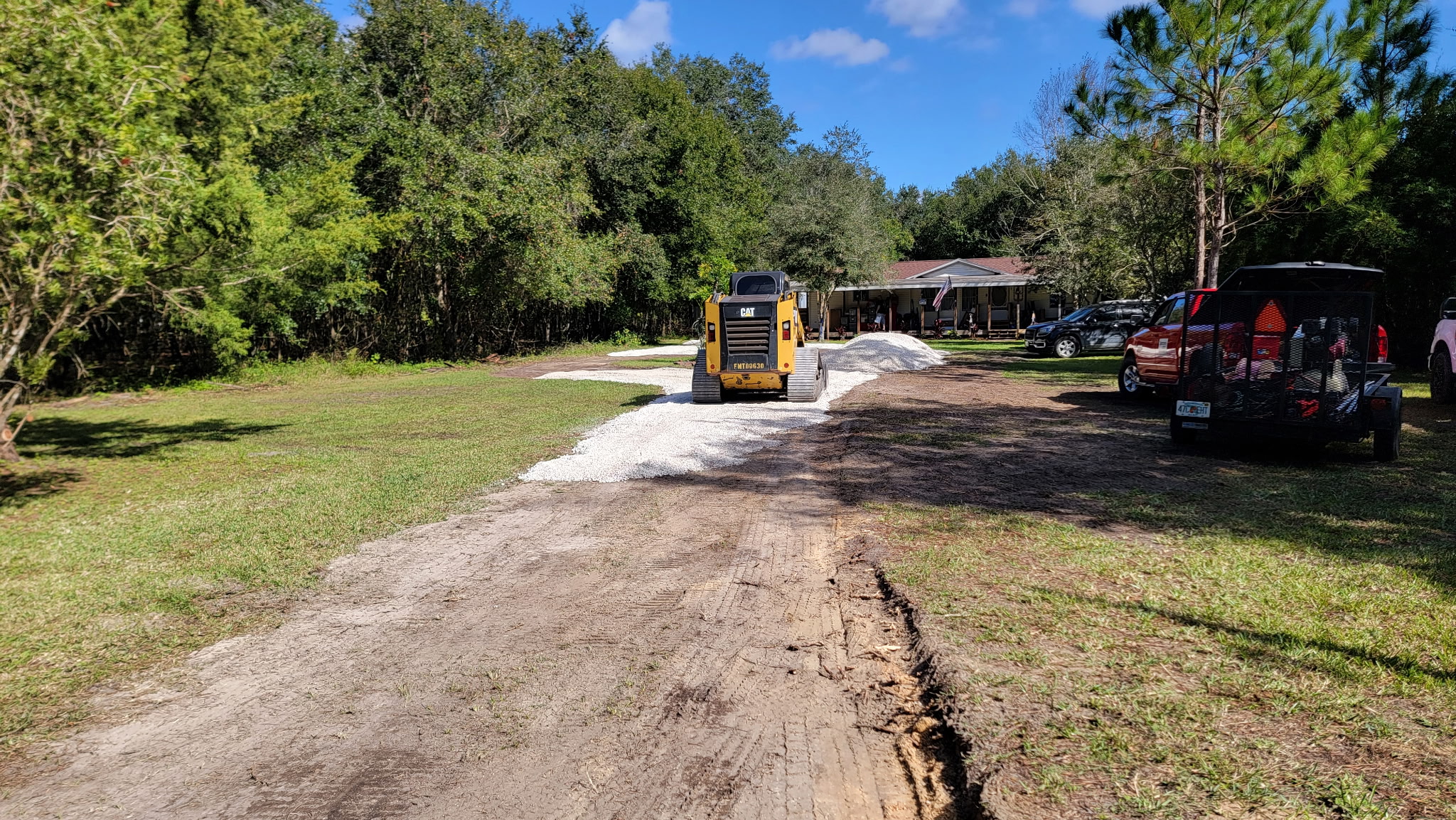 Grading a long rural driveway on a Bunnell property