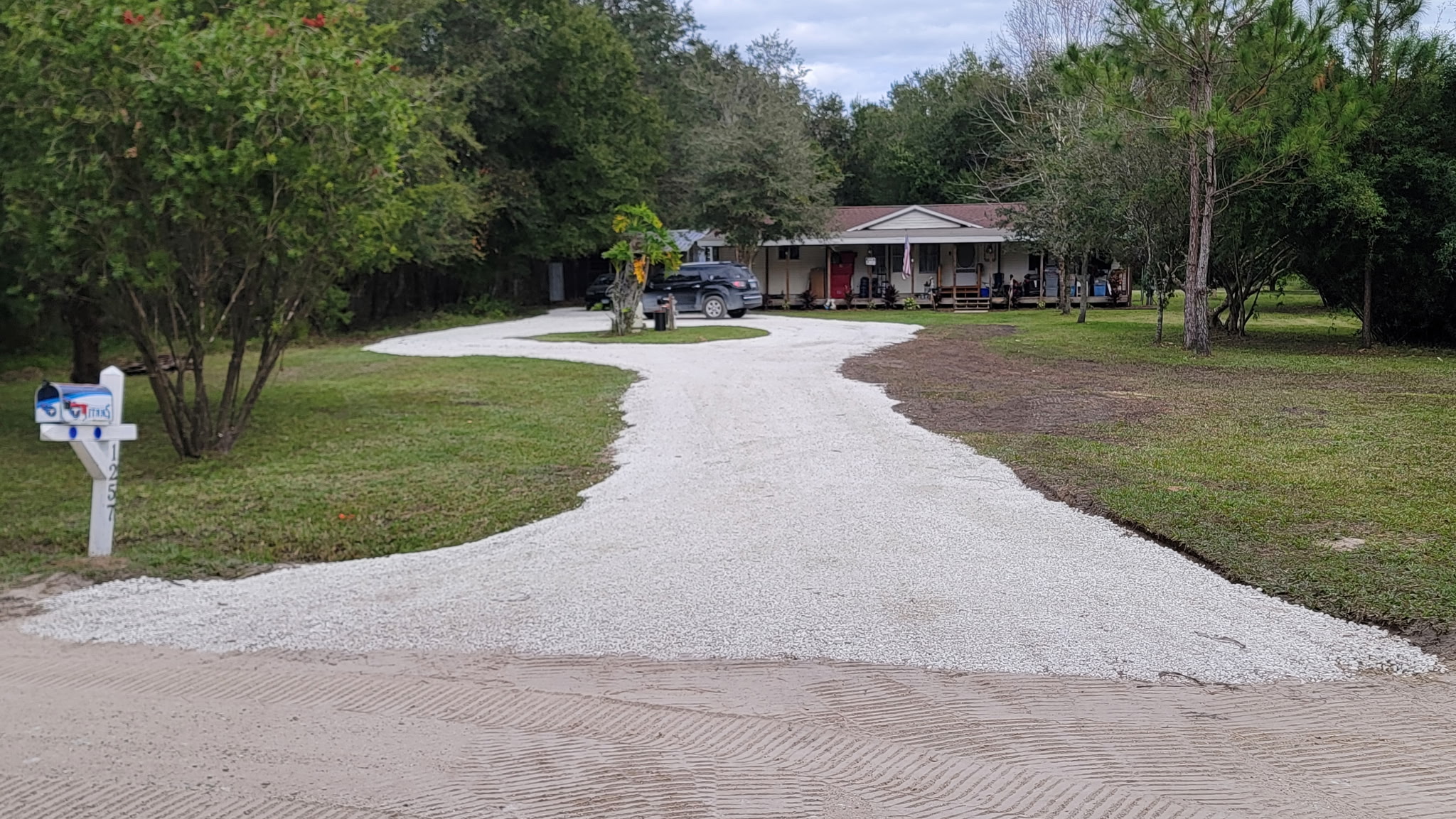 Finished crushed-shell driveway leading to a home