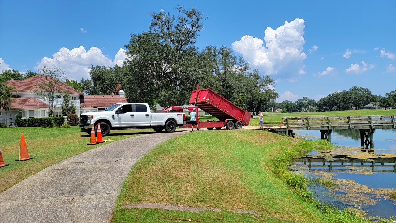 Dump trailer hauling debris from a golf course repair project