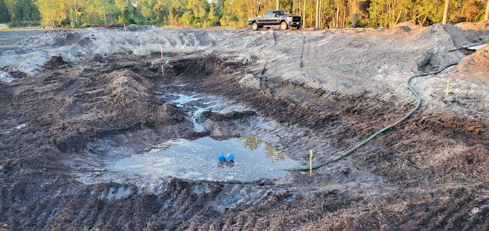 Pond excavation on a wooded Ormond Beach lot