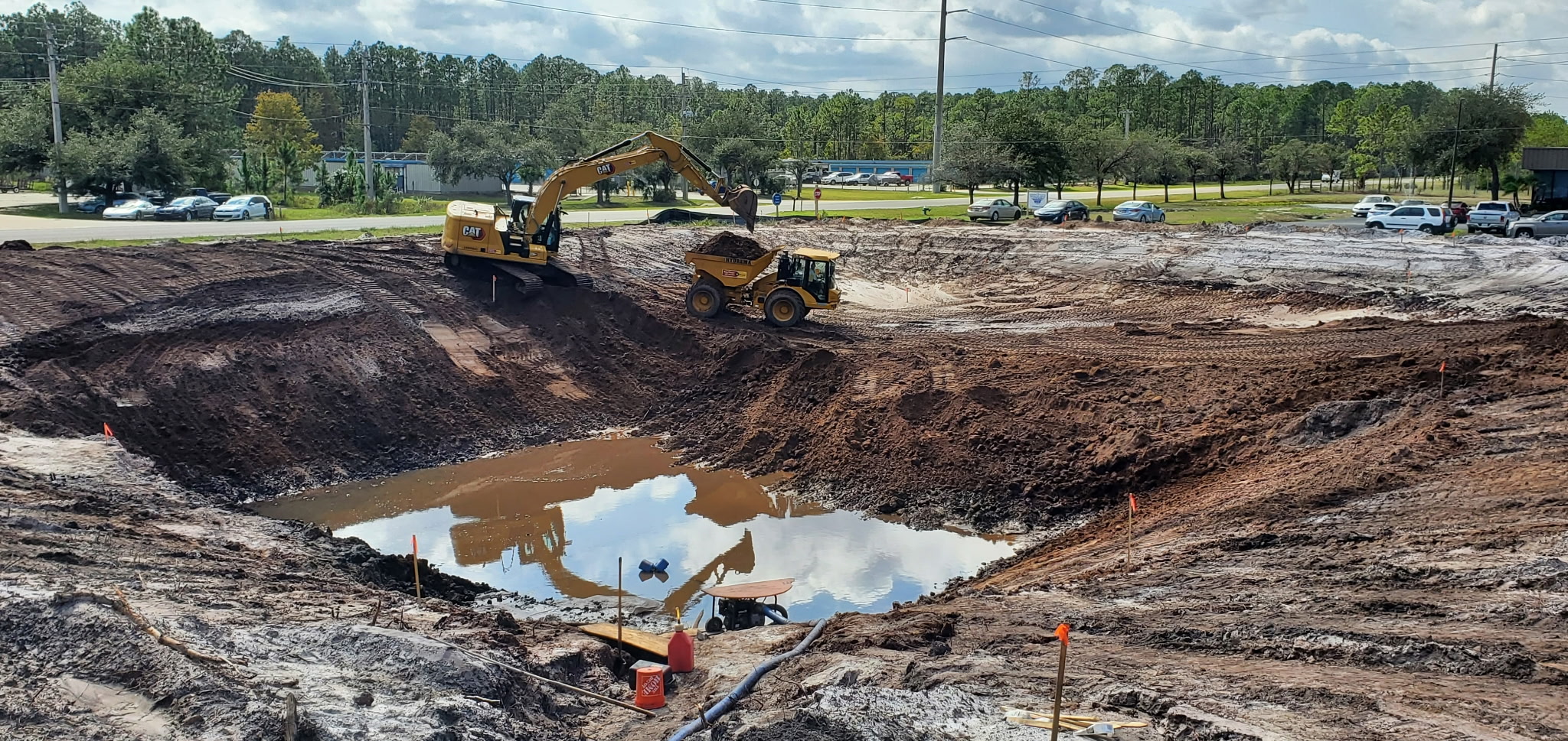 Shaping a pond bank near the Halifax River in Ormond Beach