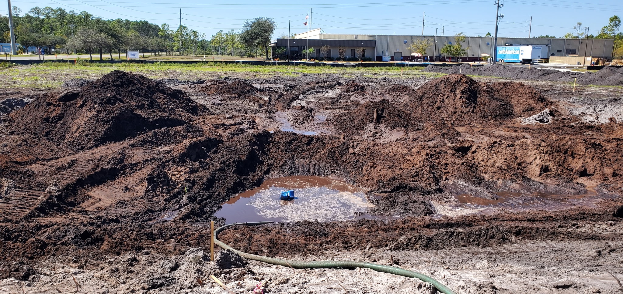 Large commercial retention pond mid-excavation