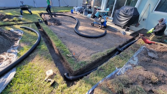 Drainage pipe installed beneath a yard before pouring a new paver patio